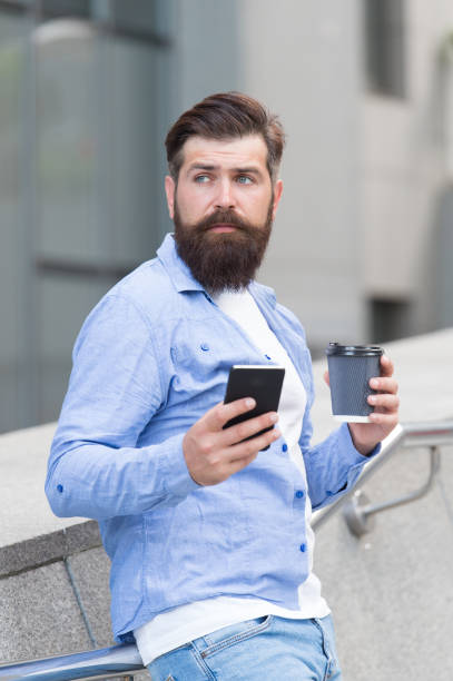 istock Life happens coffee helps. Hipster hold takeaway coffee outdoors. Bearded man enjoy drinking coffee. Hot cup. Morning time. Coffee break. Modern life. Mobile lifestyle 1325213038