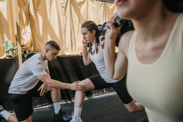 istock Personal trainer assisting a woman in training 1325214178