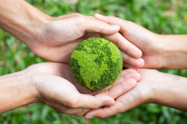 istock environment Earth Day two hands holding together a green earth. Environmental and reduce global warming help earth, top view. ecology and environment sustainable concept. 1325214227