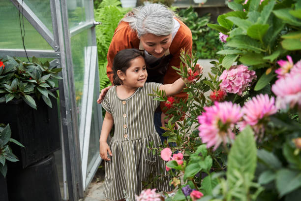istock Girl reaching for a flower while walking through the garden 1325215741