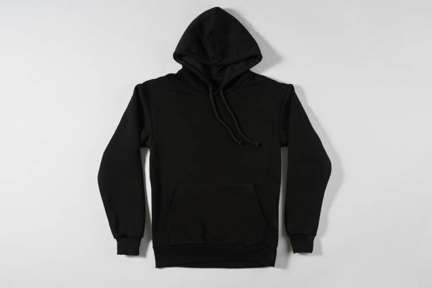 istock Black hoodie lying on a light background 1325217530