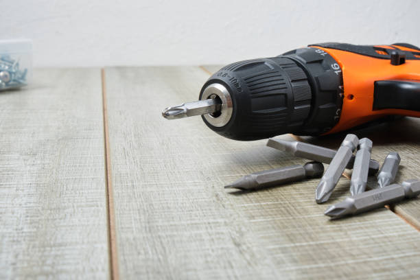 istock electric screwdriver, self-tapping screws, screwdriver bits, tool box on a wooden background 1325217702