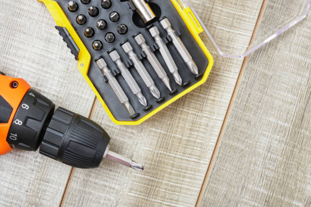 istock electric screwdriver, self-tapping screws, screwdriver bits, tool box on a wooden background 1325217726