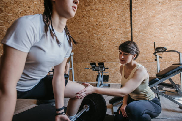 istock Female personal trainer assisting a woman training 1325217754