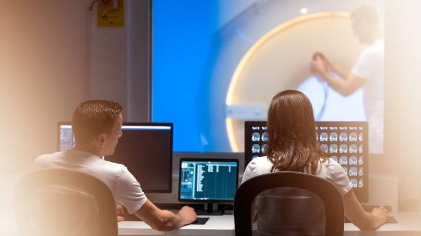 istock Doctors analyzing MRI scans in office next to scanner room 1325218041
