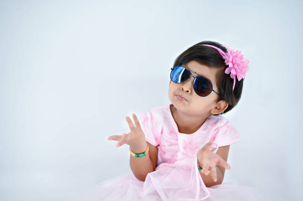 young girl kid with sunglass and saying the don’t have anything with her with white background and copy space available - facial expression child asia asian and indian ethnicities imagens e fotografias de stock