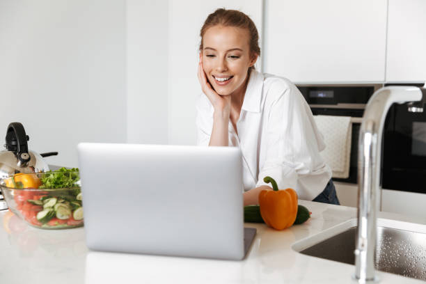 istock Pretty woman standing in kitchen indoors 1325222077