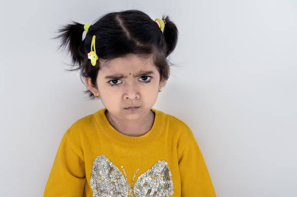 girl is angry and disappointed with school reopen. dont want to go school when you say about school and angery - facial expression child asia asian and indian ethnicities imagens e fotografias de stock