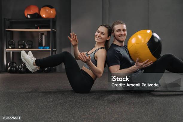 Couple Exercising Together With A Ball Stock Photo - Download Image Now - High-intensity interval training, Medicine Ball, Couple - Relationship