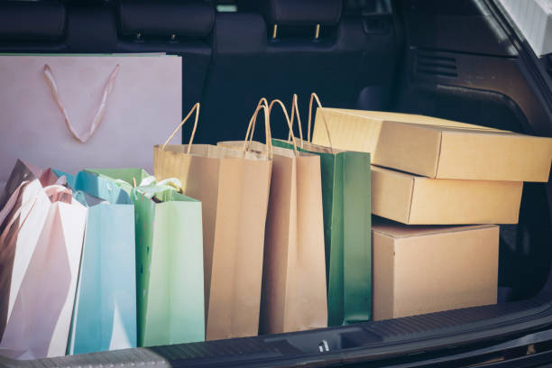 Colorful bag and brown Box in back car trunk storage. Shopping addiction. Fully paper and tote shopping bags in cart.Colorful bag and brown Box in back car trunk storage. Shopping addiction or shopaholic concept. asian women in stockings stock pictures, royalty-free photos & images