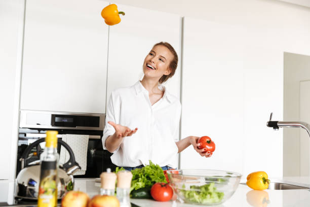 istock Beautiful woman standing in kitchen cooking 1325225881