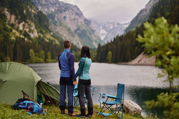 Affectionate couple relaxing near a lake while camping Affectionate couple relaxing near a lake while camping durmitor national park photos stock pictures, royalty-free photos & images