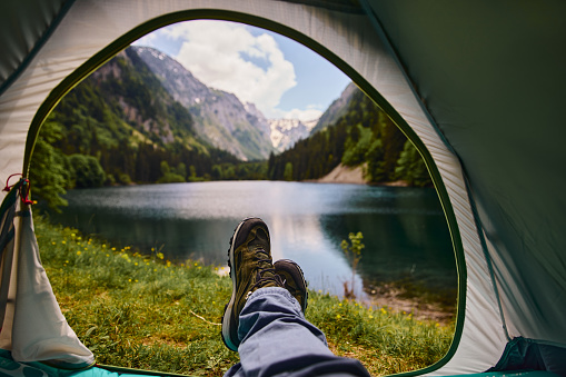 View of the lake and mountains through the open window of the tent