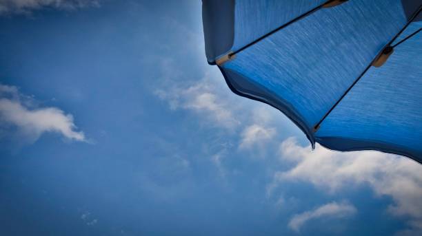 detail of a blue umbrella on the beach by the Ligurian sea, in Spotorno detail of a blue umbrella on the beach by the Ligurian sea, in Spotorno. During the Italian summer beach umbrella photos stock pictures, royalty-free photos & images