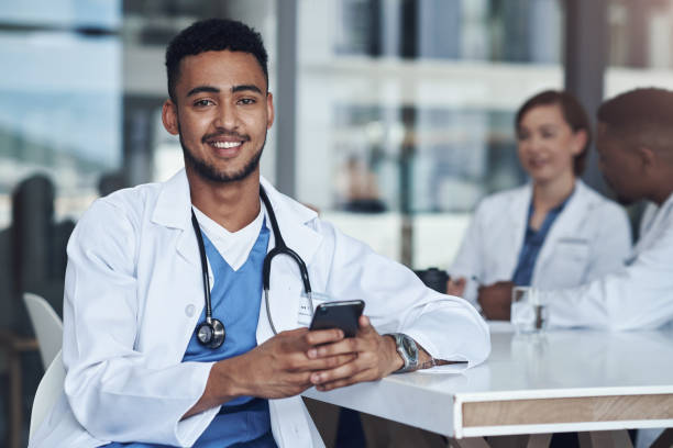 istock Shot of a young male doctor using his smartphone while taking a break 1325231676