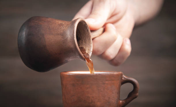 istock Male hand pouring coffee into cup. 1325231868