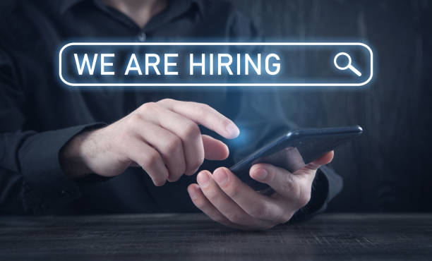 istock Man using smartphone. We Are Hiring. Recruiting and Employment 1325231885