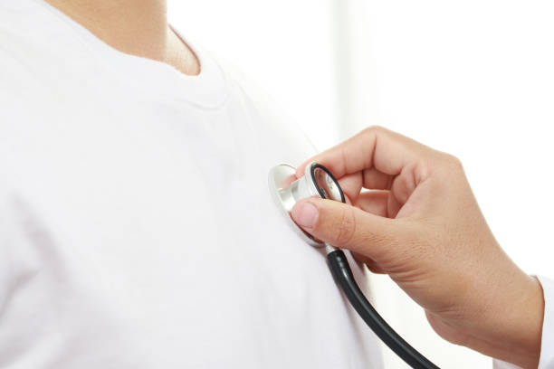 Doctor checking heart wave with patient at hospital