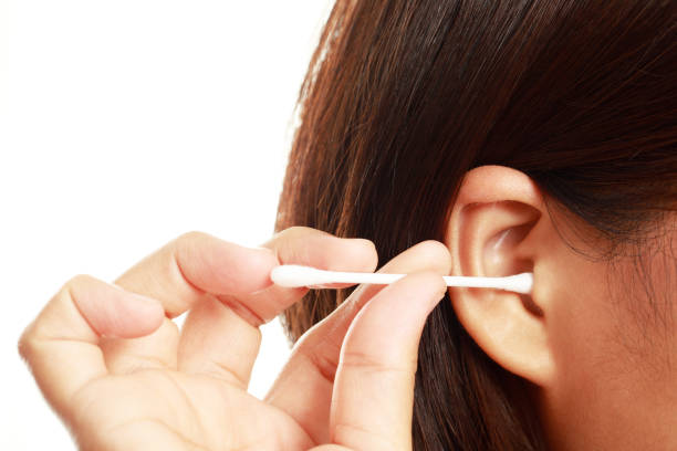 istock Woman is cleaning ear with a cotton bus 1325232016