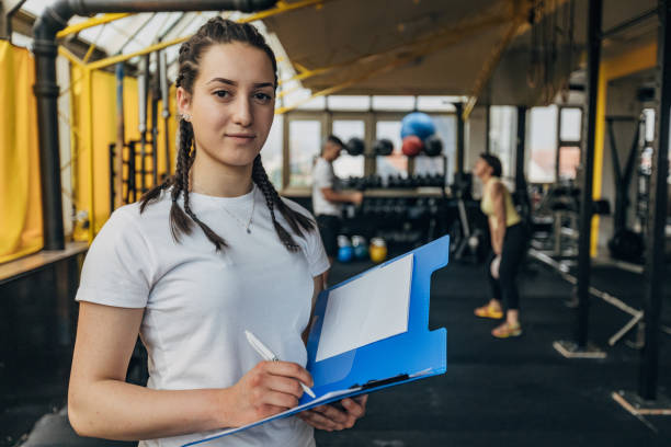 Female fitness trainer writing schedule