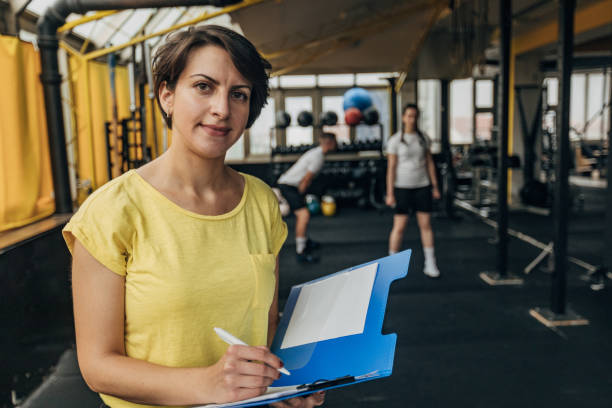 istock Female fitness trainer writing schedule 1325234302