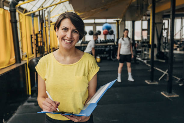 istock Female fitness trainer writing schedule 1325234560