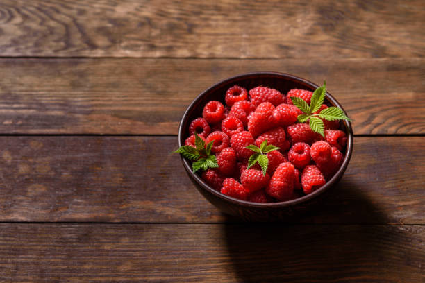 istock Delicious fresh juicy red raspberries on a dark table 1325236567