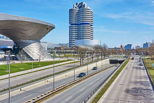 Munich, Germany - March 28, 2021: Traffic on the Georg Brauchle Ring in Munich. In the background the BMW dealership.