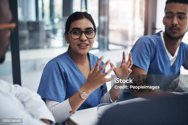 Shot Of Medical Nurses Having A Meeting With Their Doctors Stock Photo - Download Image Now