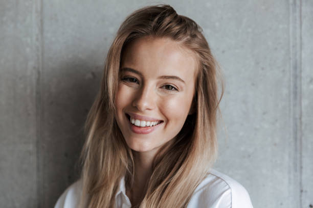 istock Beautiful young woman indoors over grey wall 1325238669
