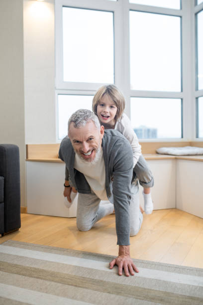 istock Dad and kids having fun at home and looking excited 1325239835