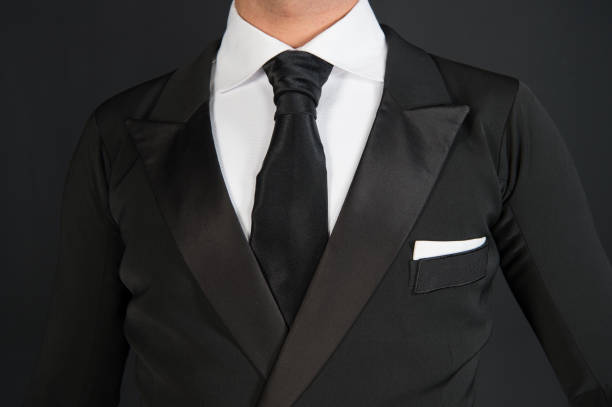 istock Man in a black tuxedo suit and white shirt 1325239935