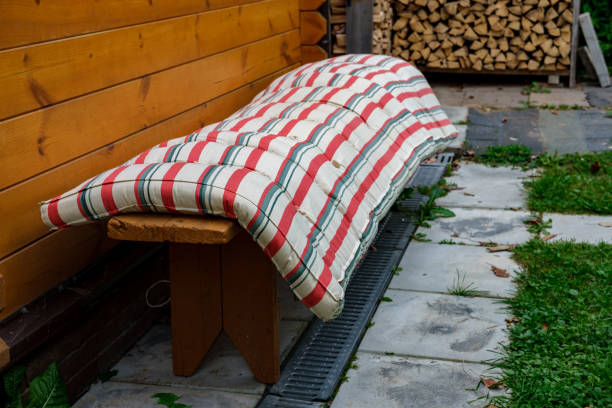 The old mattress is drying on the bench.