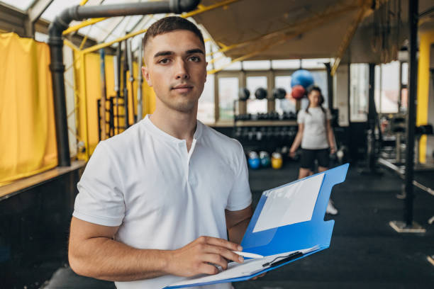 istock Male fitness trainer writing schedule 1325242716