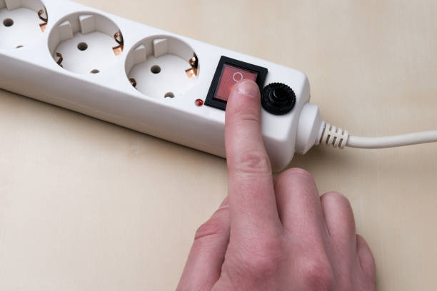 istock The man turns on the socket with his finger. 1325243814