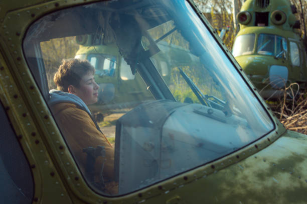 istock A young man on board an old abandoned Soviet plane. The guy looks out the window. 1325249643