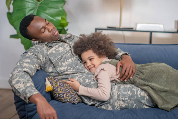 istock Military with closed eyes and hugging happy daughter 1325250151
