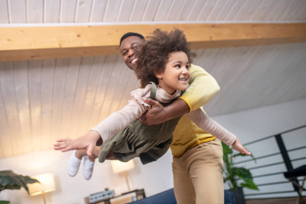 istock Dad holding his daughter in air 1325250175