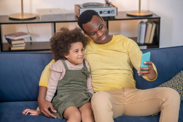 istock Dad with little daughter taking selfie on smartphone 1325250185