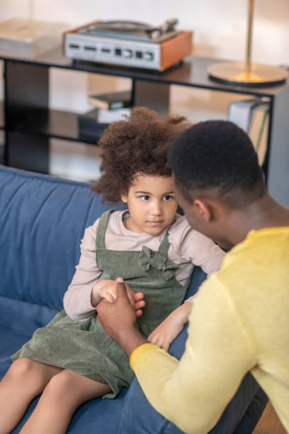 istock Dad holding hand sad little daughter 1325250201