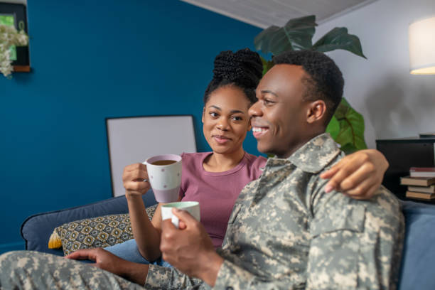 istock Military and wife drinking coffee on couch 1325250265