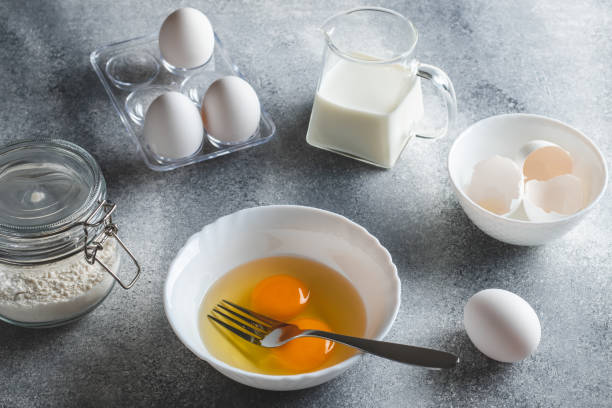 istock Raw ingredients for making an omelet. Eggs and flour on a gray background. Cooking concept. 1325250322