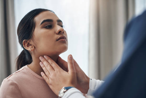 Shot of an unrecognizable doctor feeling a patient's throat in an office I'm just going to feel for any swelling throat stock pictures, royalty-free photos & images