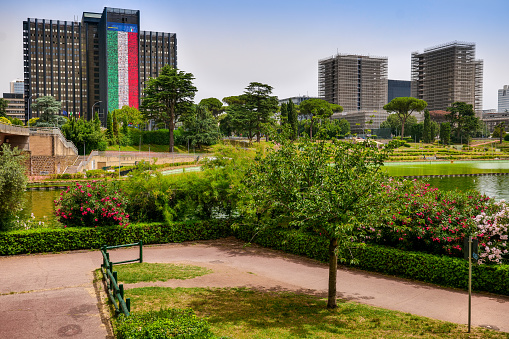 Rome, Italy, June 21 -- TThe central park of Lake EUR with the modern skyline of the business district of Rome, with some corporate buildings under construction (right). Image in high definition format.