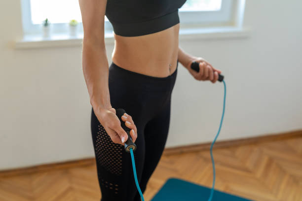 istock Woman rope skipping home workout 1325251778