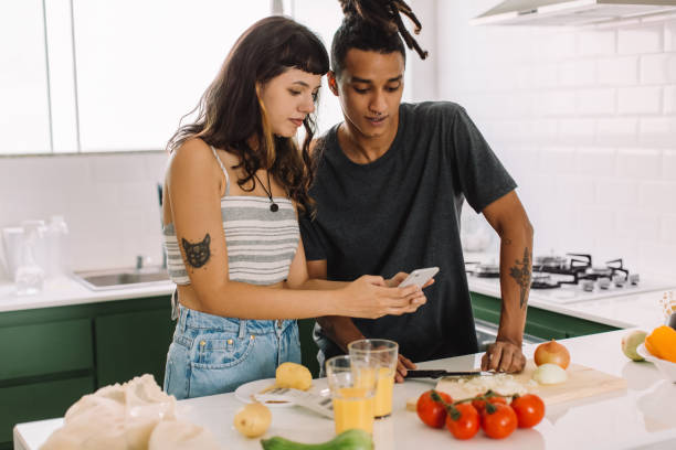 istock Young couple using an online recipe at home 1325254153