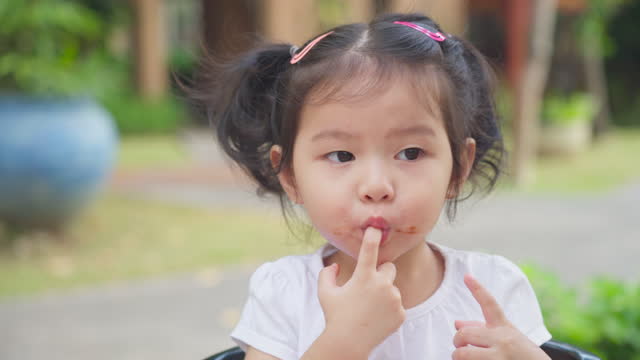 Little girl Enjoy Sweet Chocolate time.