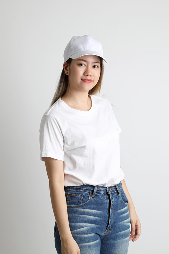 The young Asian woman posing on the white background.