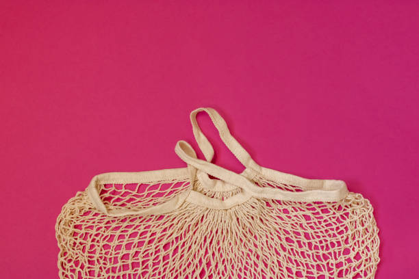 istock Zero waste concept. Empty reusable eco shopping bag on a pink background. String bag for delivery. Top view. Copy space. 1325256875