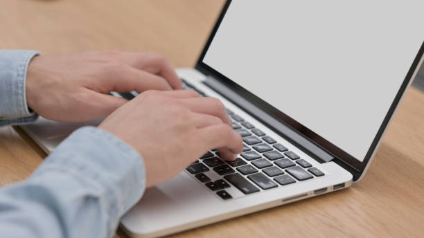 istock Hands of Man Typing on Laptop Keyboard, Close up 1325256991
